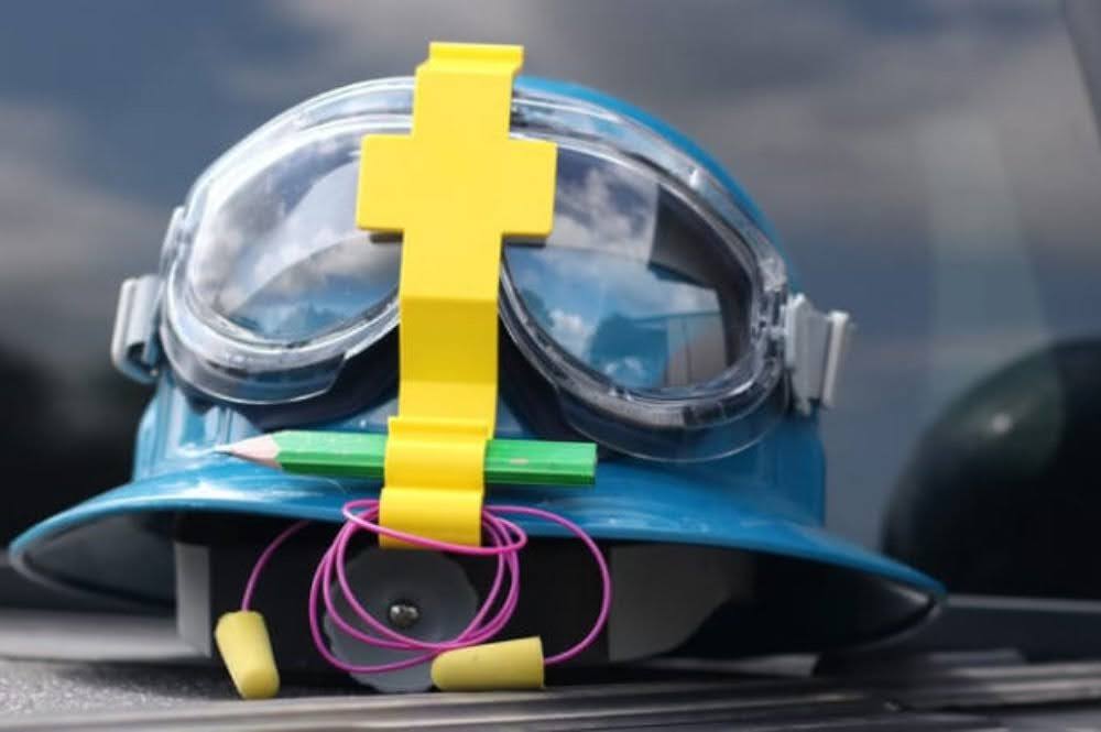 A helmet featuring PPE equipment and ear buds for enhanced safety.